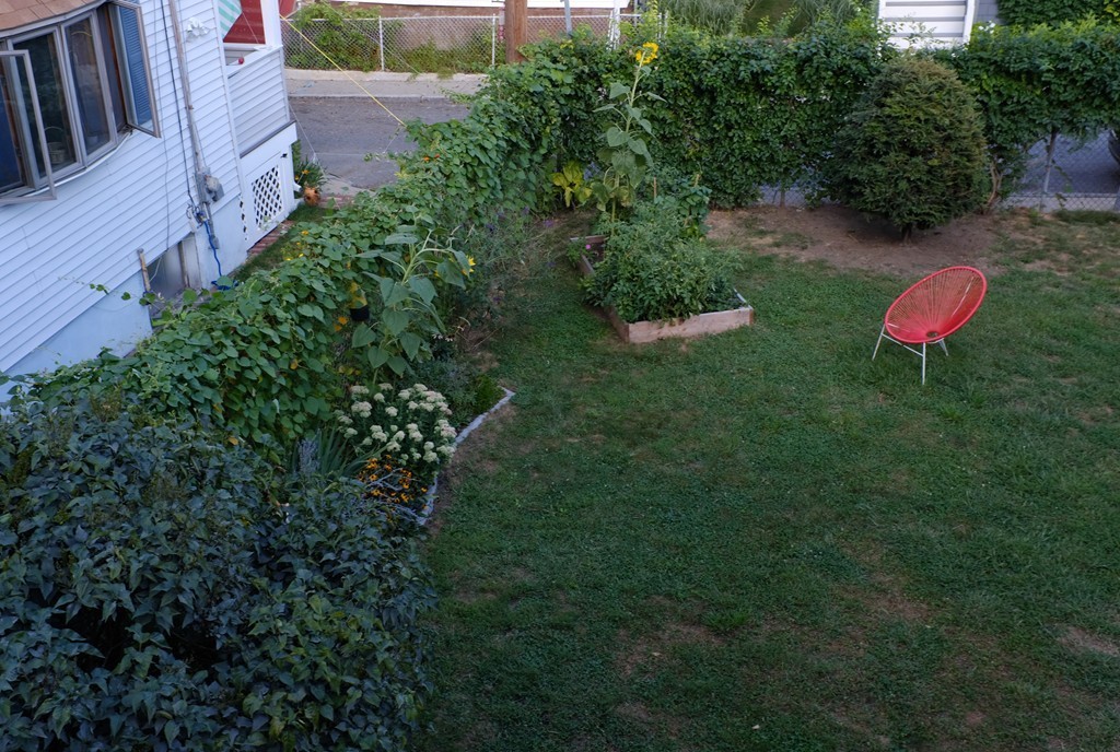 56 Hinckley Street, Unit 2 Somerville, MA 02145 - Photo 15 of 18 a backyard of a house with a yard and outdoor seating