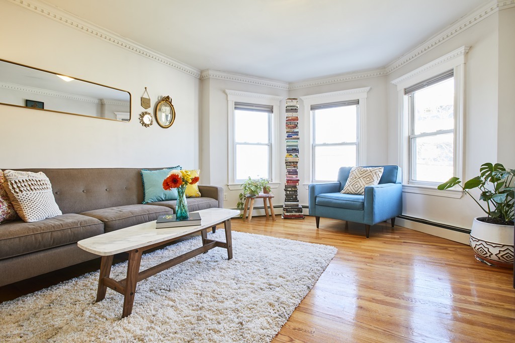 56 Hinckley Street, Unit 2 Somerville, MA 02145 - Photo 2 of 18 a living room with furniture and wooden floor