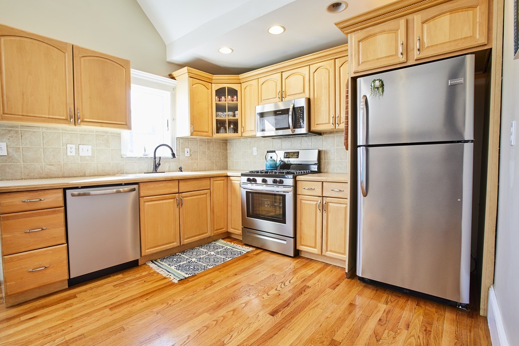 56 Hinckley Street, Unit 2 Somerville, MA 02145 - Photo 5 of 18 a kitchen with a refrigerator sink and cabinets