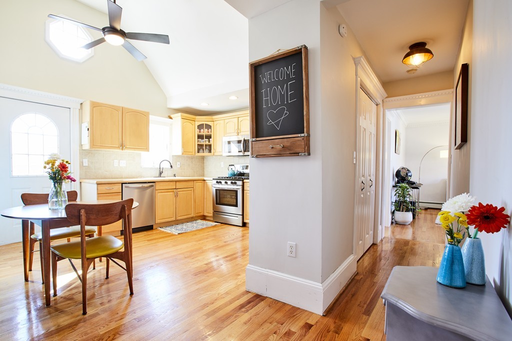 56 Hinckley Street, Unit 2 Somerville, MA 02145 - Photo 6 of 18 a view of kitchen with furniture and wooden floor