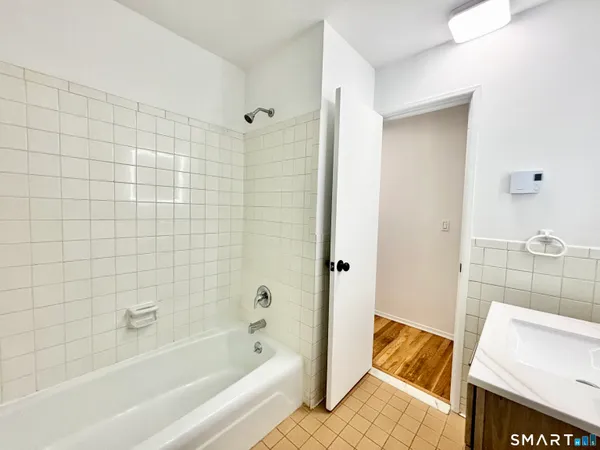 a bathroom with a bathtub and shower