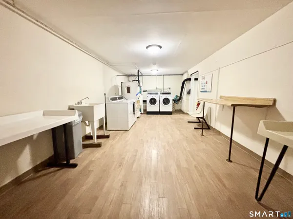 a view of a kitchen with furniture and wooden floor
