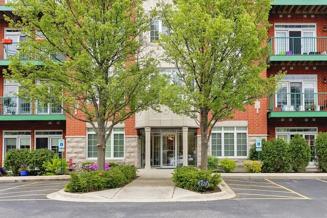 front view of a brick house with a yard