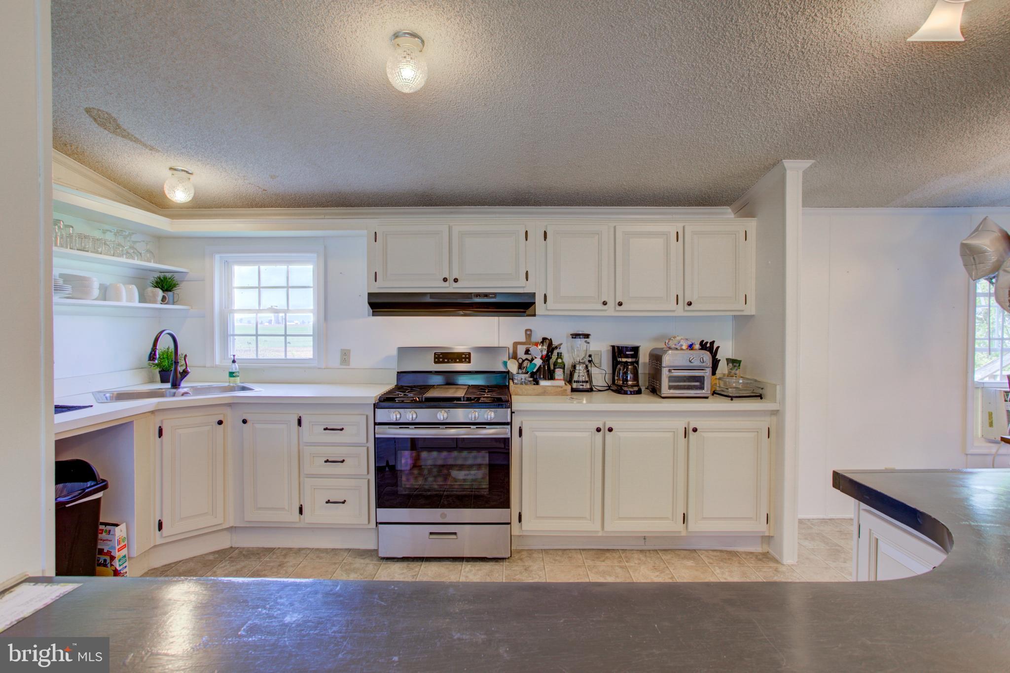 494 Compass Road Gap, PA 17527 - Photo 125 of 127 a kitchen with stainless steel appliances granite countertop a stove a sink and white cabinets