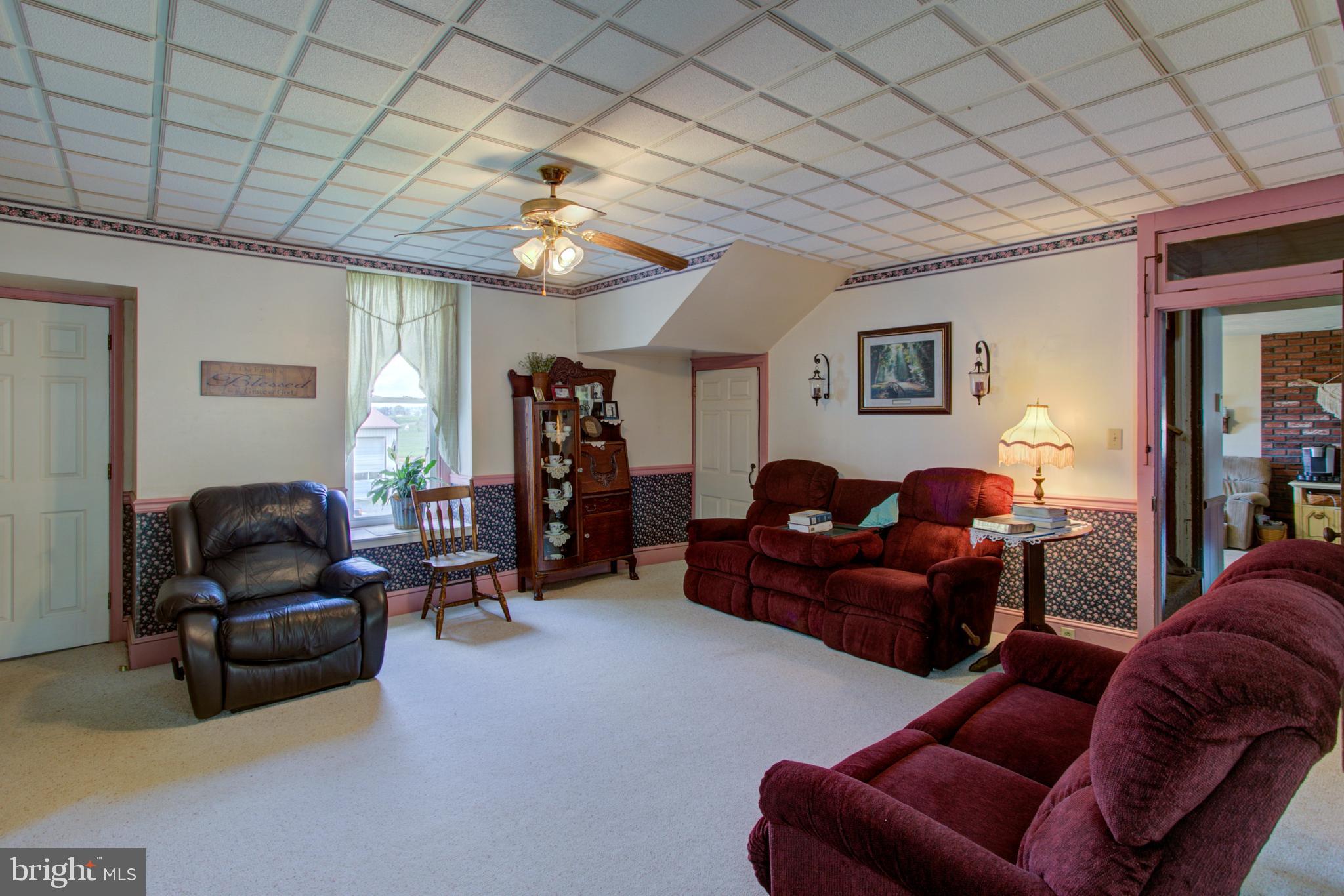 494 Compass Road Gap, PA 17527 - Photo 67 of 127 a living room with furniture ceiling fan and a rug