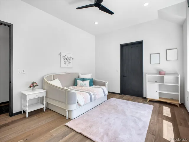 a living room with a bed and furniture