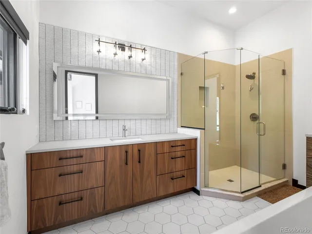 a bathroom with a double vanity sink mirror and a shower