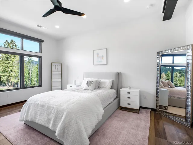 a bedroom with a bed and a large window