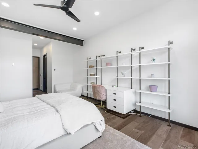 a bedroom with furniture and white walls