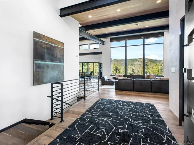 a living room with a couch and floor to ceiling window