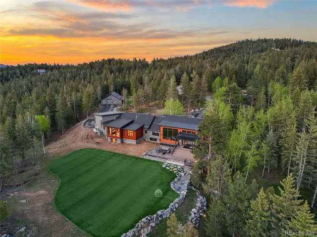 an aerial view of a house with mountain view