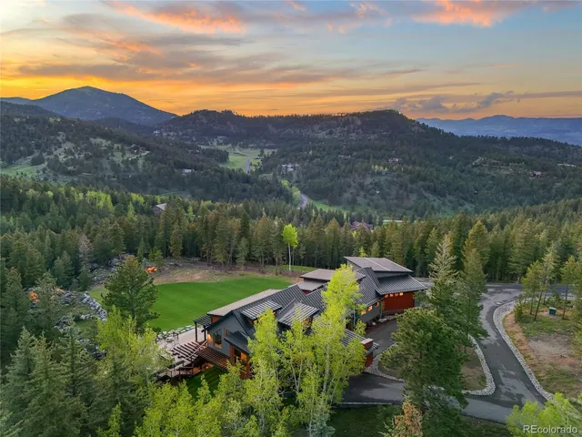 a view of a lush green hillside and houses