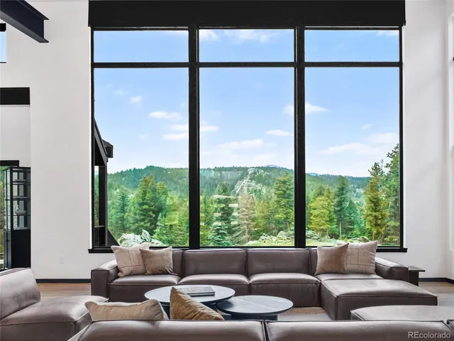 a living room with furniture city view and windows