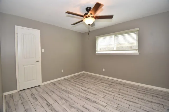 wooden floor in an empty room with a window