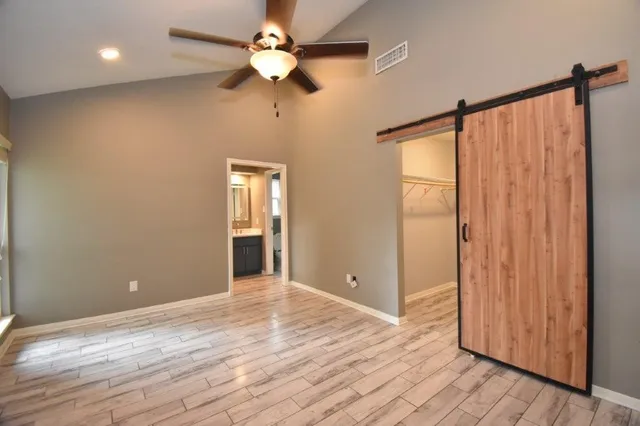 a view of a room with wooden floor and windows