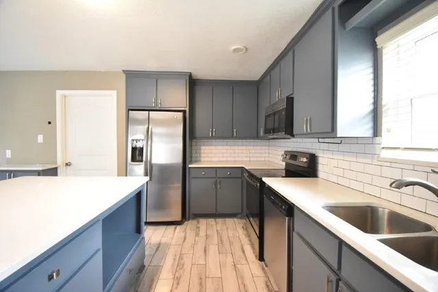 a view of a room with wooden floor and large windows