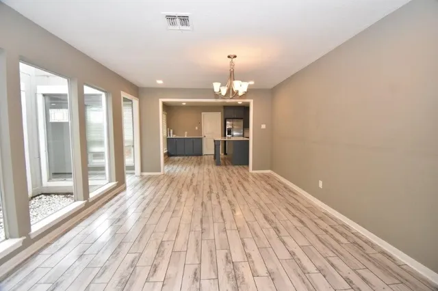 a view of an empty room with a fireplace and a window