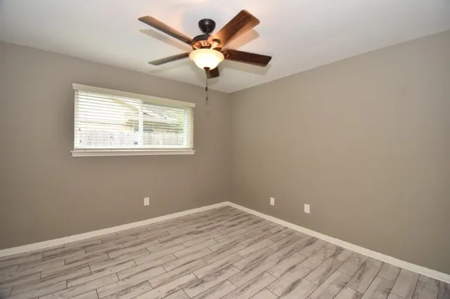 a white toilet sitting next to a bath tub
