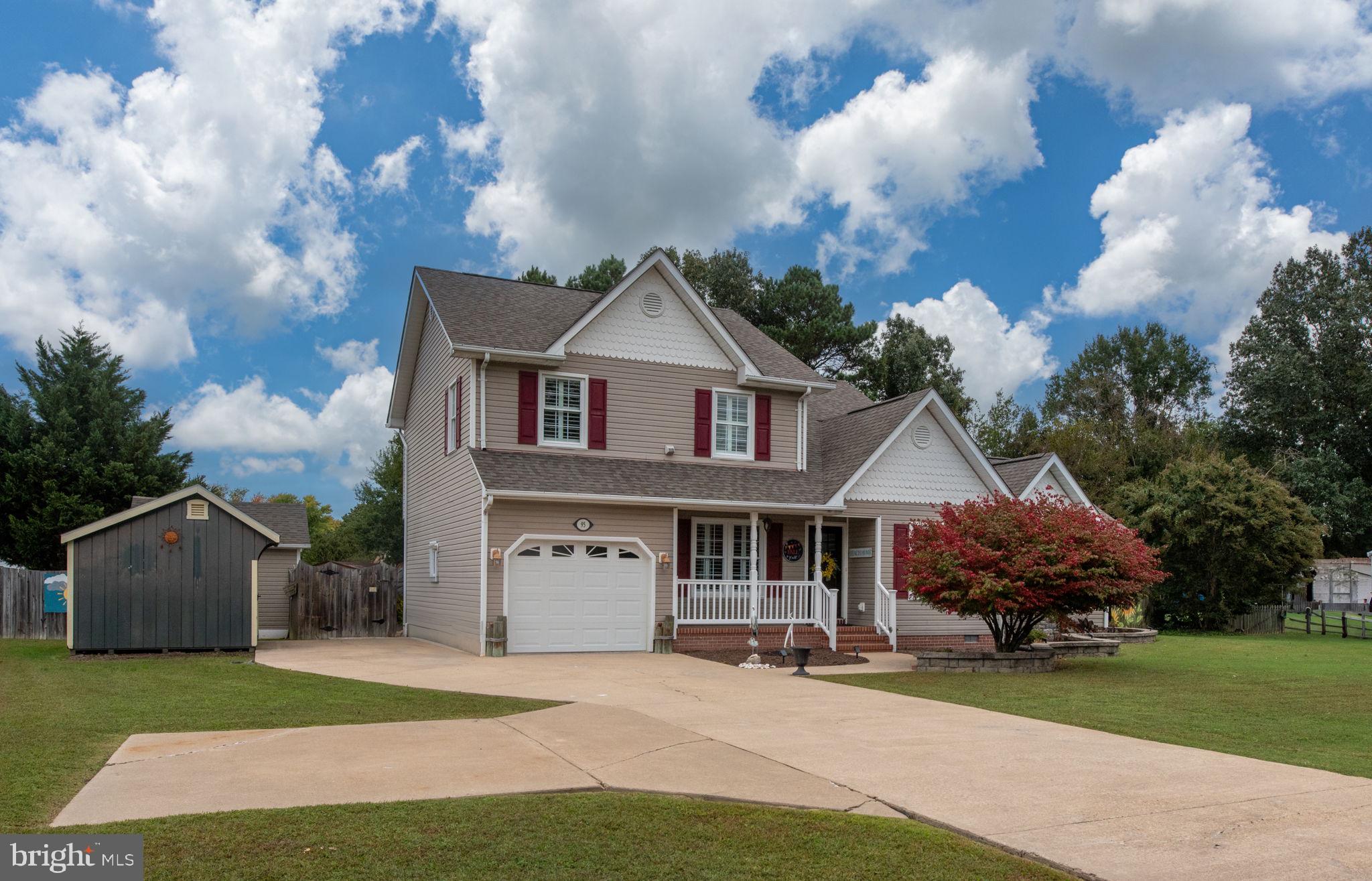 95 Potomac Lane Colonial Beach, VA 22443 - Photo 2 of 101 a front view of a house with a garden and trees