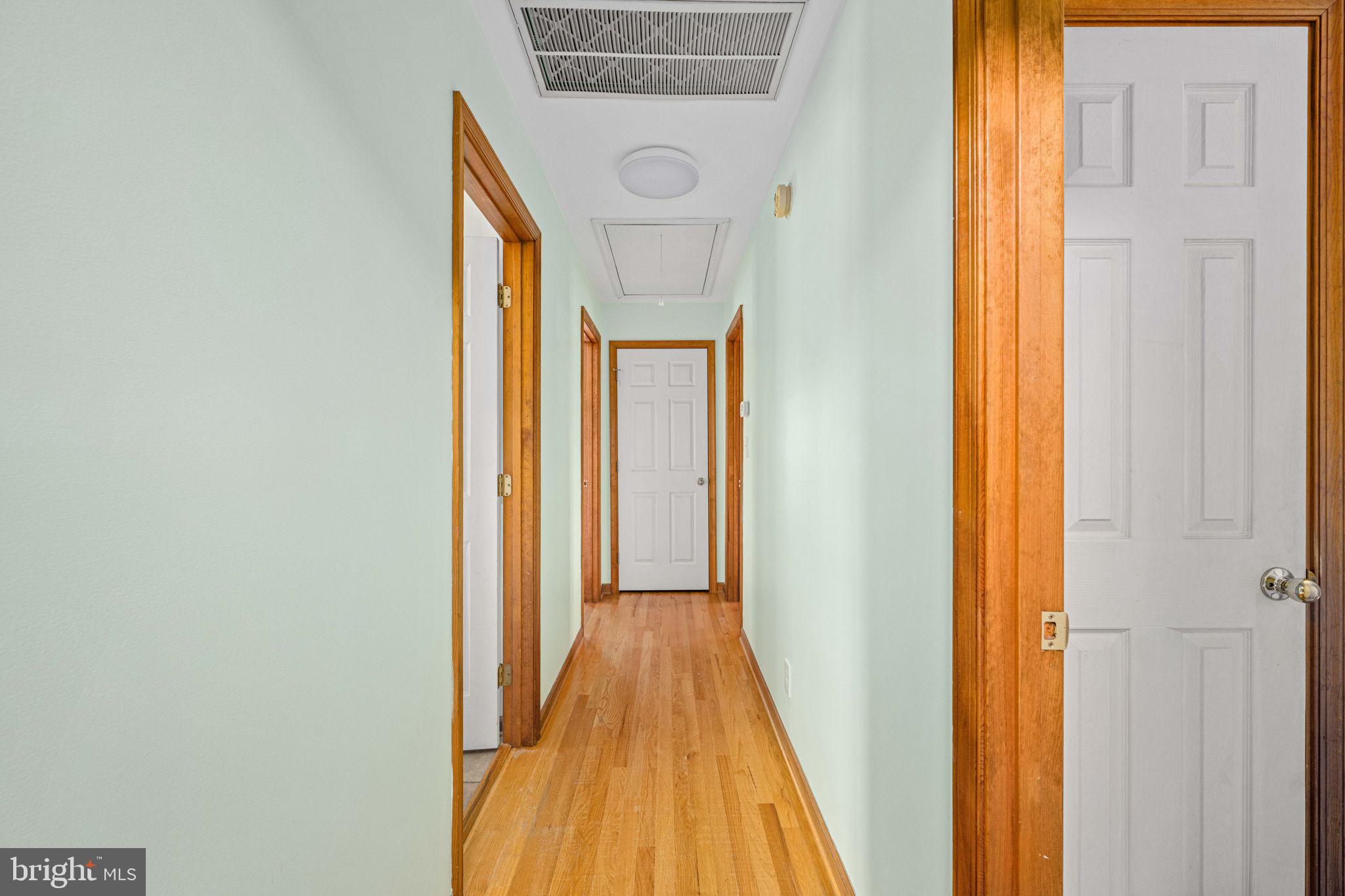 95 Potomac Lane Colonial Beach, VA 22443 - Photo 80 of 101 a view of a hallway with wooden floor and a bathroom