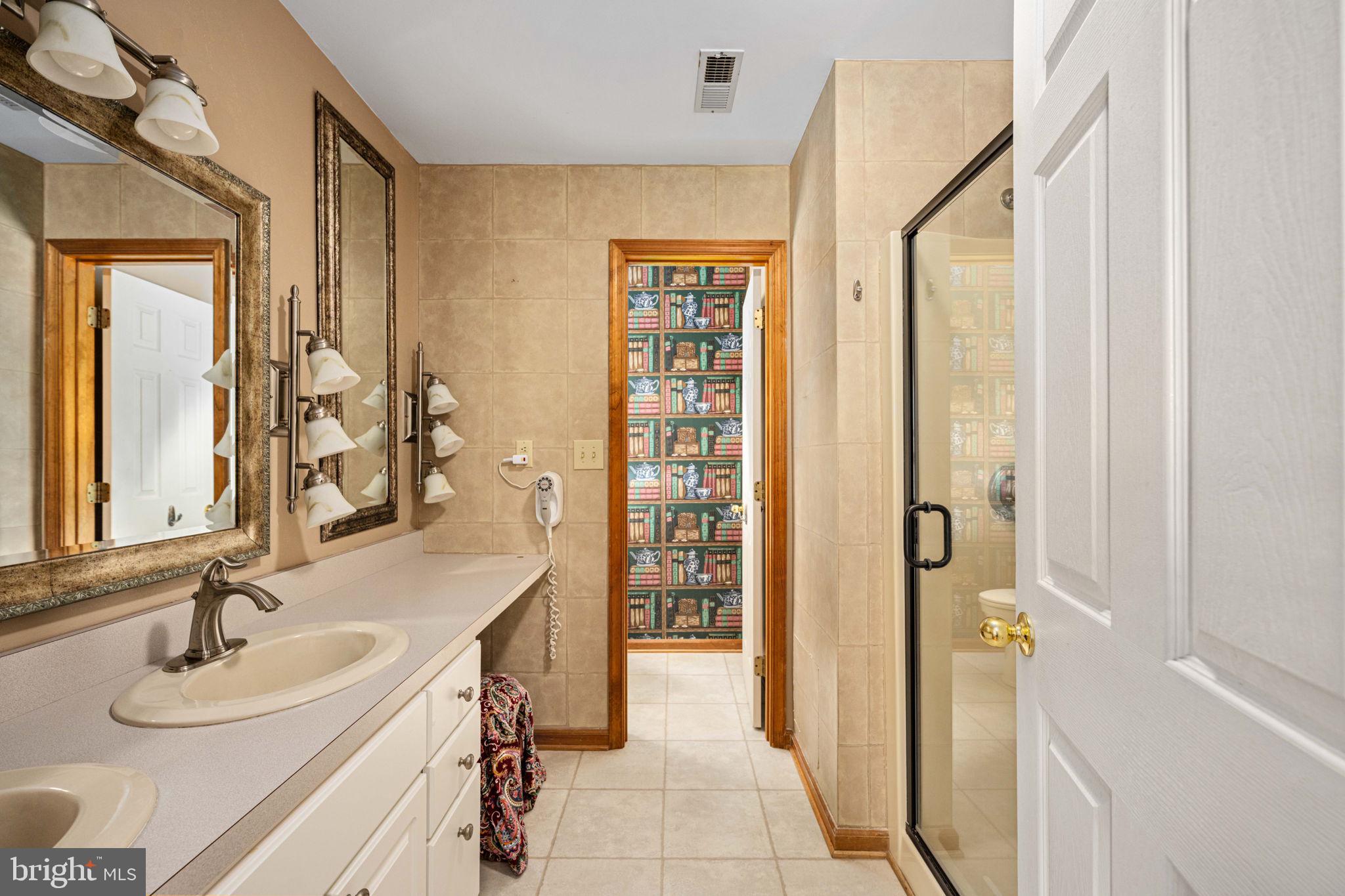 95 Potomac Lane Colonial Beach, VA 22443 - Photo 86 of 101 a bathroom with a double vanity sink a mirror and a shower