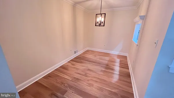an empty room with wooden floor