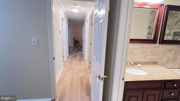 a view of a room with wooden floor and fan