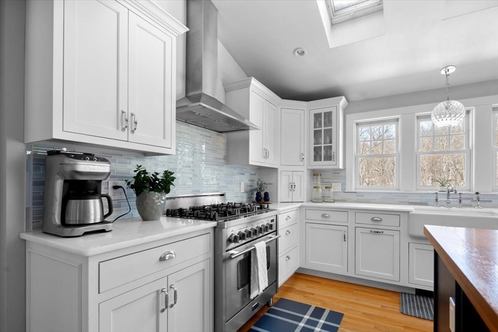 8 Village Lane Hingham, MA 02043 - Photo 12 of 36 a kitchen with cabinets stainless steel appliances a sink and wooden floor
