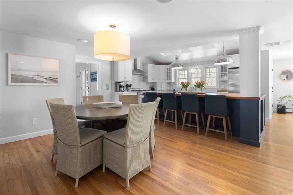 8 Village Lane Hingham, MA 02043 - Photo 13 of 36 a dining room with furniture a chandelier and wooden floor