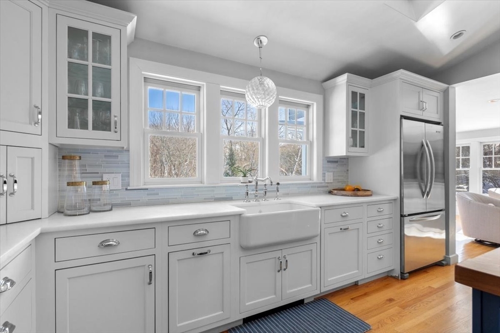 8 Village Lane Hingham, MA 02043 - Photo 7 of 36 a kitchen with white cabinets and a sink