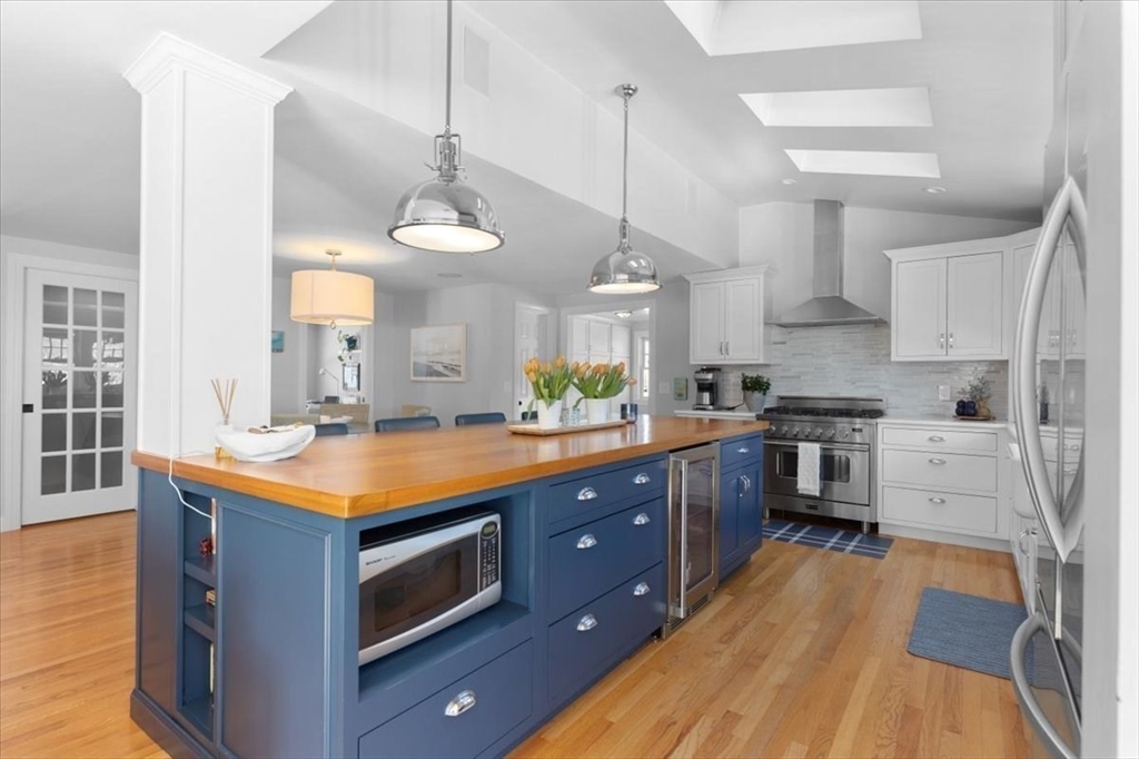 8 Village Lane Hingham, MA 02043 - Photo 8 of 36 a kitchen with stainless steel appliances granite countertop a sink a stove and a wooden floors