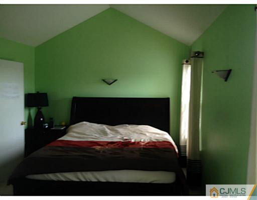 179 Salem Road North Brunswick, NJ 08902 - Photo 14 of 23 a bedroom with a bed and a potted plant