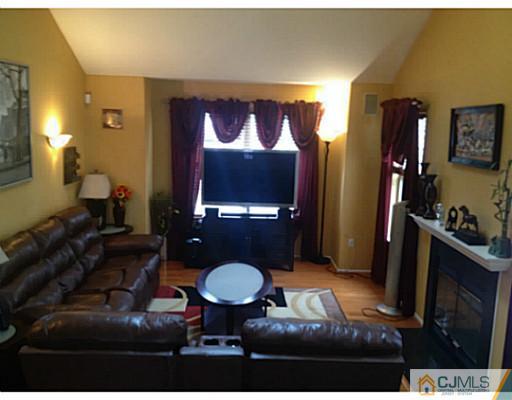 179 Salem Road North Brunswick, NJ 08902 - Photo 3 of 23 a living room with furniture a rug and a flat screen tv