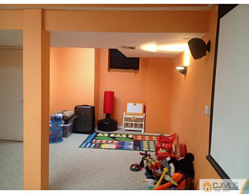 179 Salem Road North Brunswick, NJ 08902 - Photo 9 of 23 a room with furniture and a flat screen tv