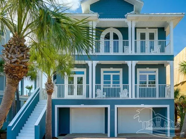 a front view of a house with a tree