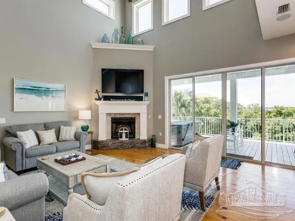 a living room with furniture fireplace and a flat screen tv