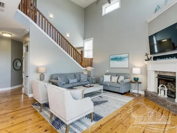 a living room with furniture a flat screen tv and a fireplace