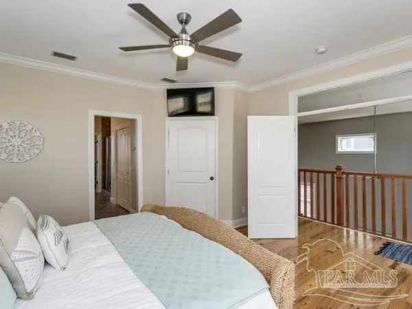 a bedroom with a large bed and a chandelier