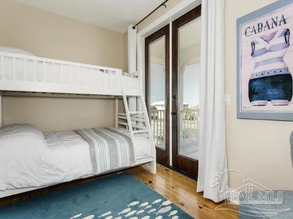 a bedroom with a bed and a mirror