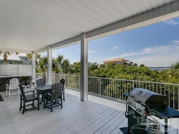 a view of a roof deck with furniture