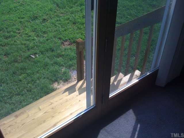 2616 Ellis Chapel Road Bahama, NC 27503 - Photo 4 of 11 a view of a glass door with a yard from a balcony