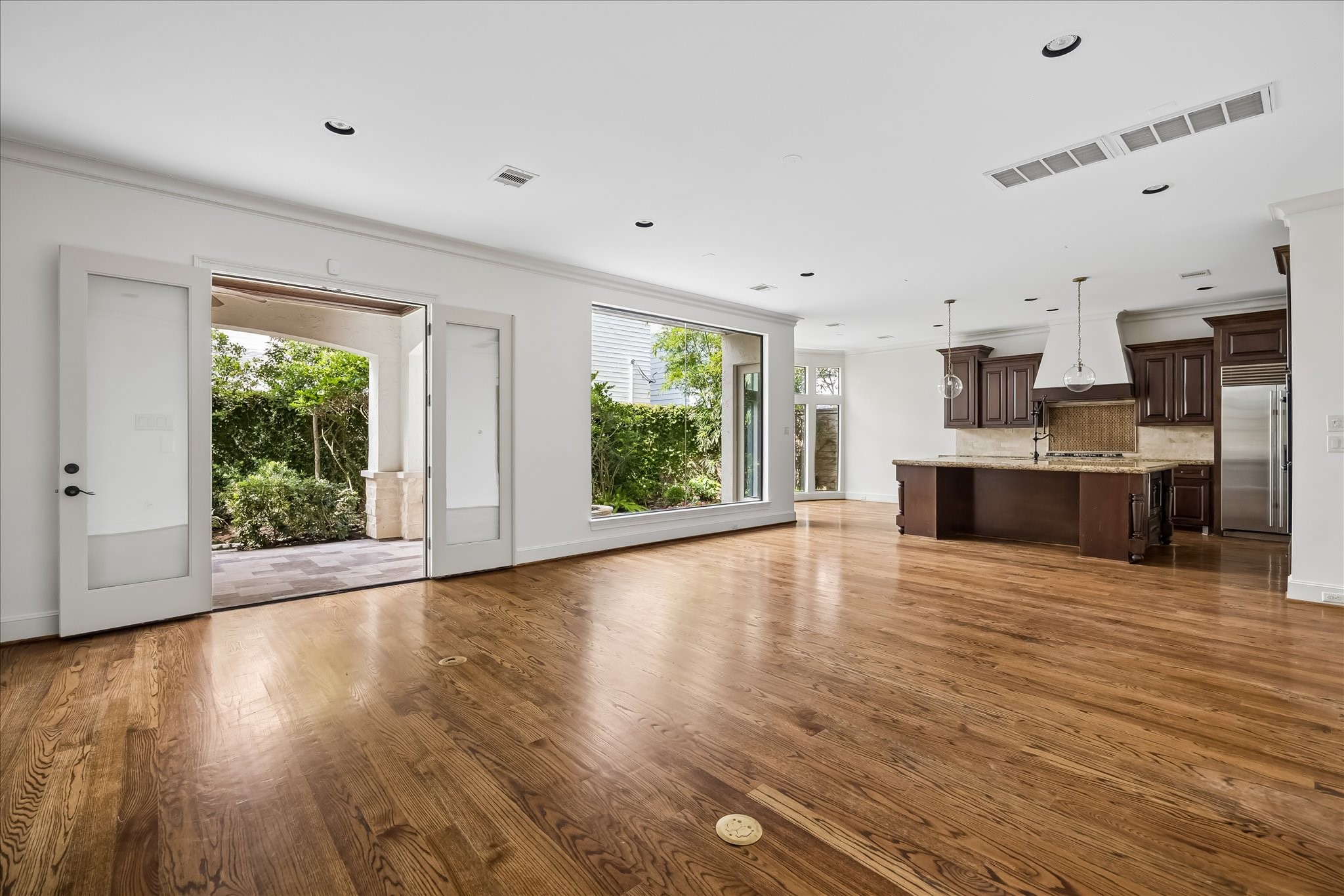 2246 Branard Street Houston, TX 77098 - Photo 20 of 40 From this angle, notice the family rooms seamless flow to the kitchen, breakfast area, and covered outdoor living spaces.