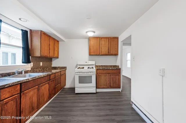 a kitchen with stainless steel appliances a stove top oven and sink