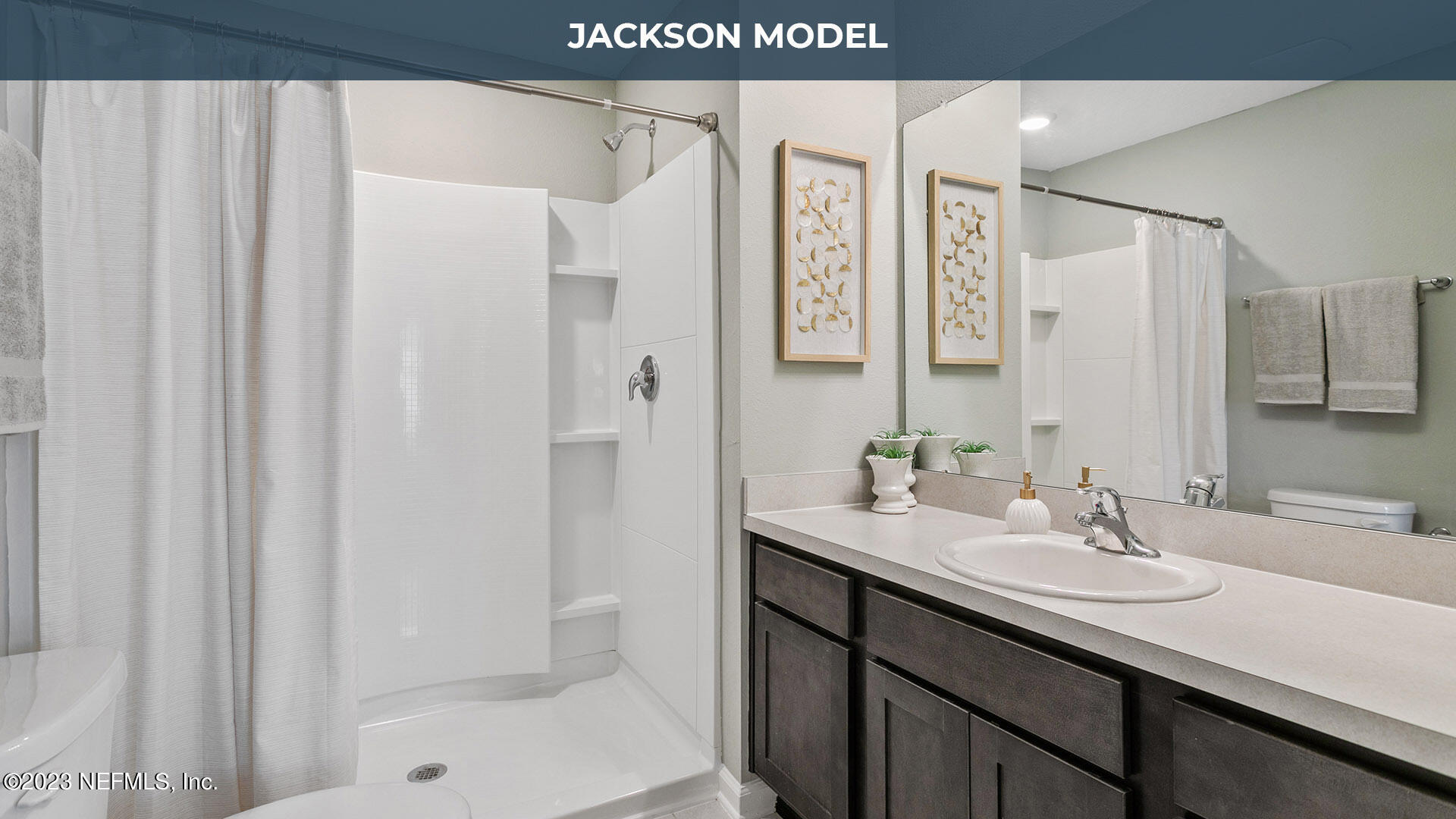 8357 Retrograde Road Jacksonville, FL 32256 - Photo 10 of 34 a bathroom with a sink a mirror and a shower