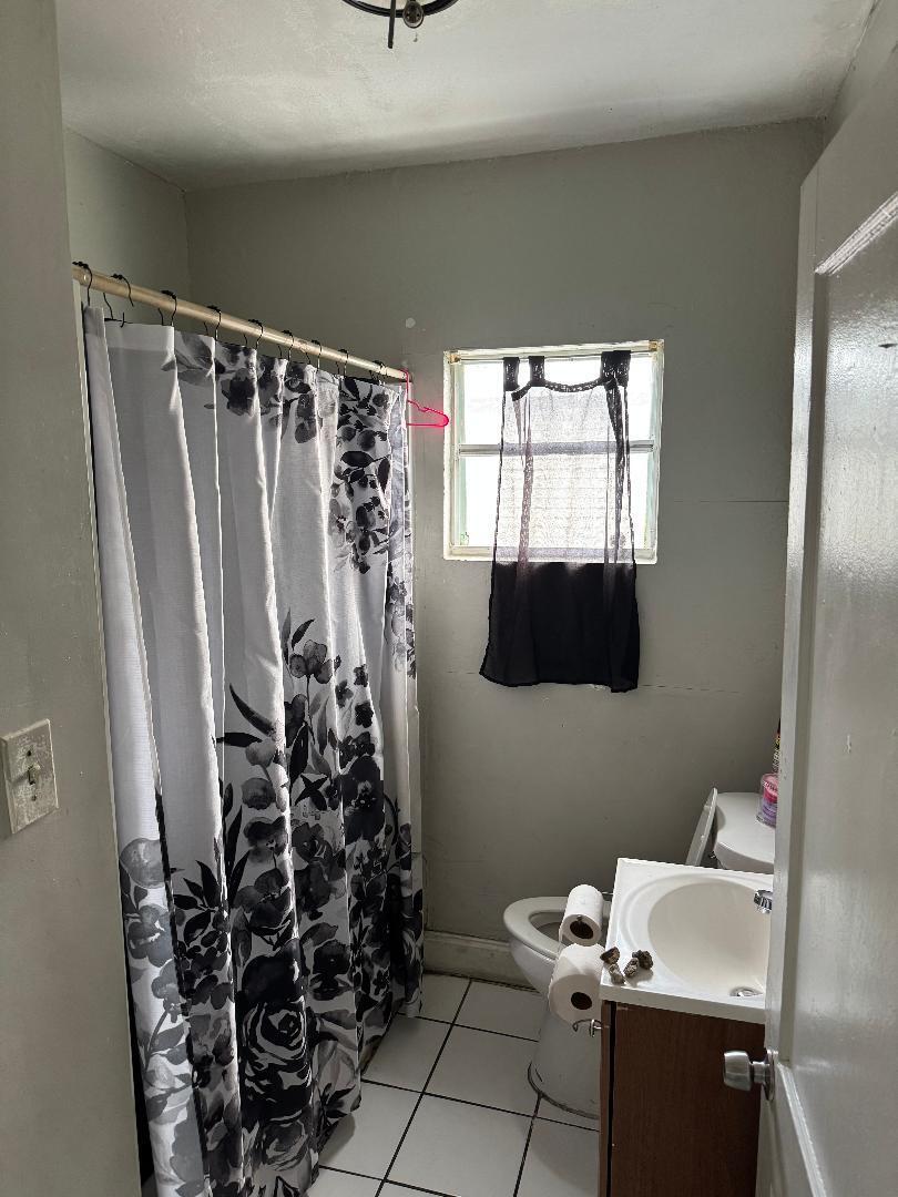 511 Texas Court Fort Pierce, FL 34950 - Photo 9 of 15 a bathroom with a sink toilet and shower