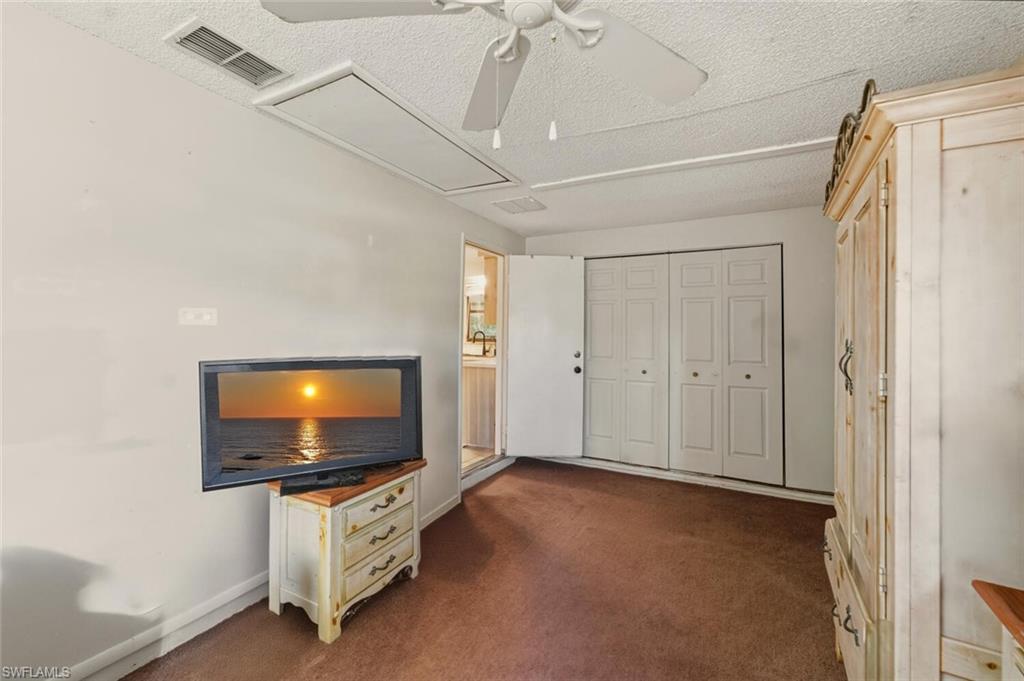 2747 47th Street Southwest Naples, FL 34116 - Photo 11 of 21 a living room with furniture and a flat screen tv