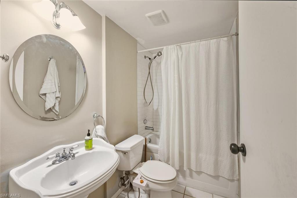 2747 47th Street Southwest Naples, FL 34116 - Photo 12 of 21 a bathroom with a toilet a sink and a mirror