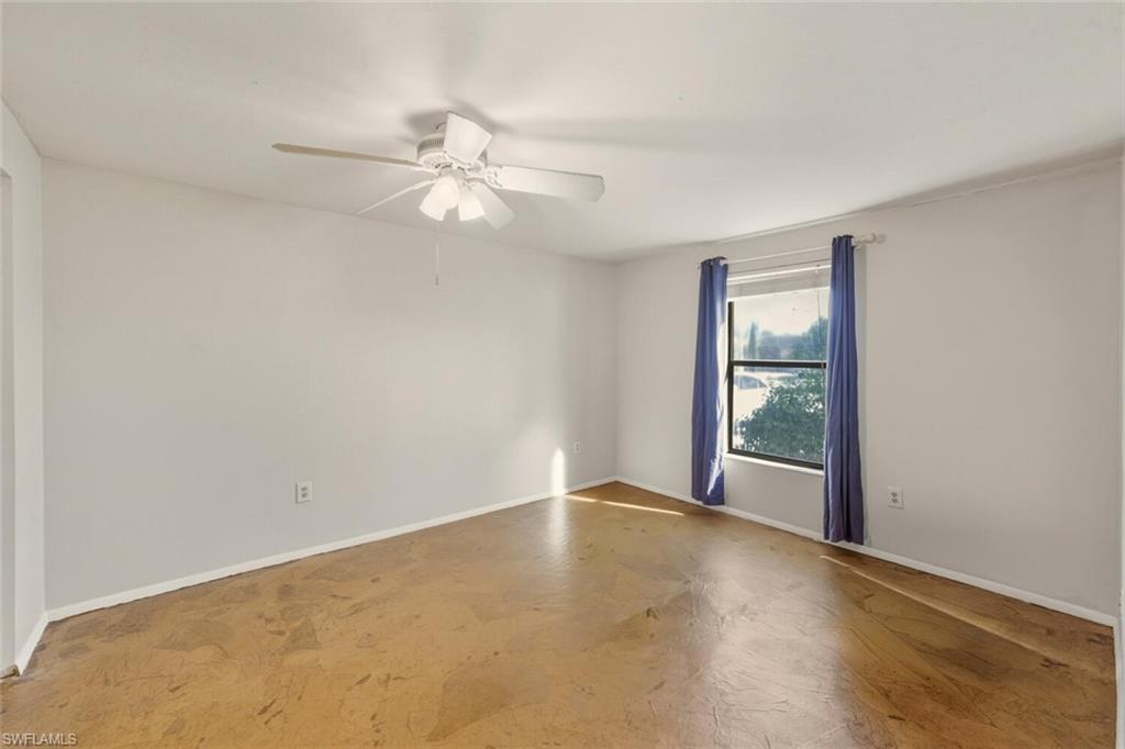 2747 47th Street Southwest Naples, FL 34116 - Photo 13 of 21 an empty room with windows and fan