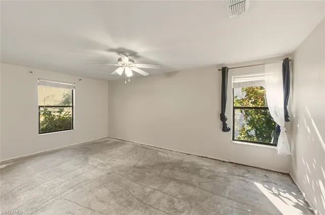 an empty room with windows and closet