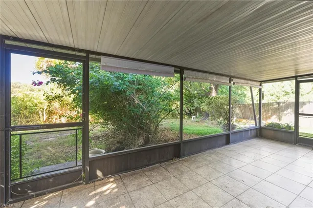 a view of a porch with chairs and backyard